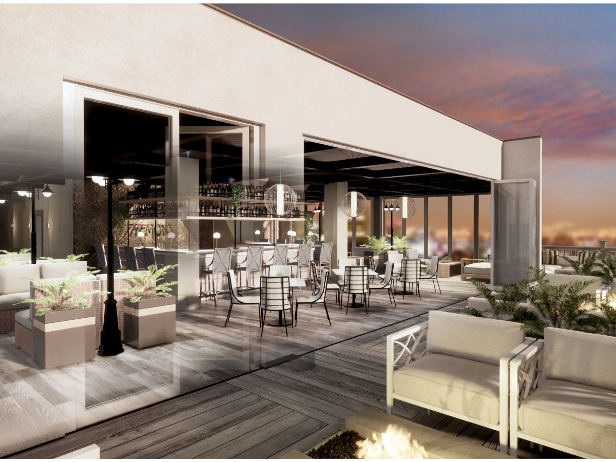 An upscale outdoor rooftop patio with modern seating, potted plants, and warm lighting during sunset, offering a scenic view of the city.